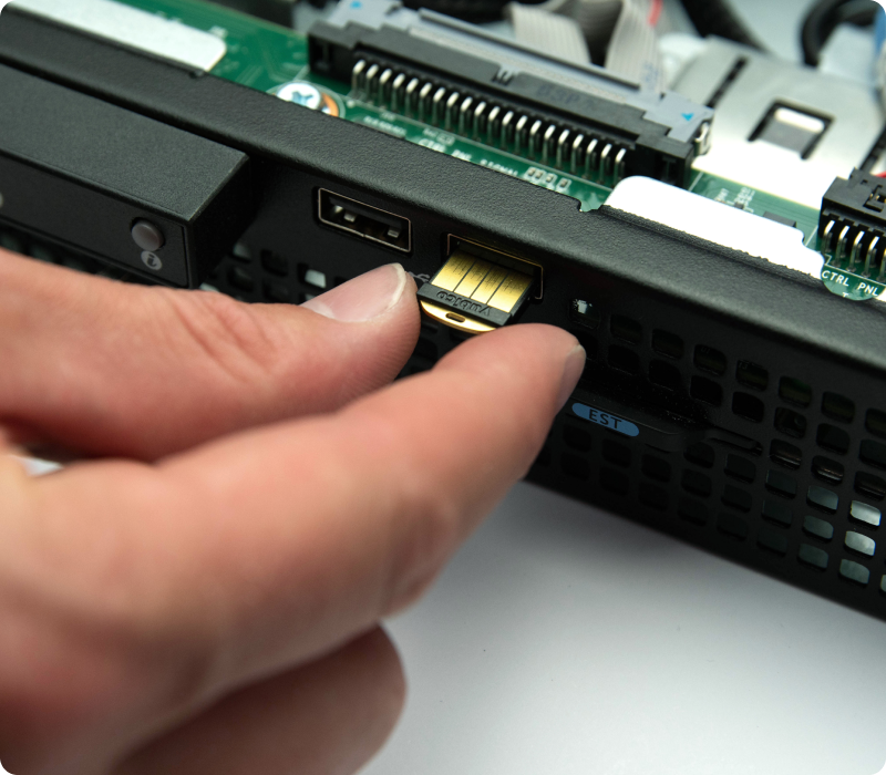 A YubiHSM 2 being inserted into the front USB port of a rack server